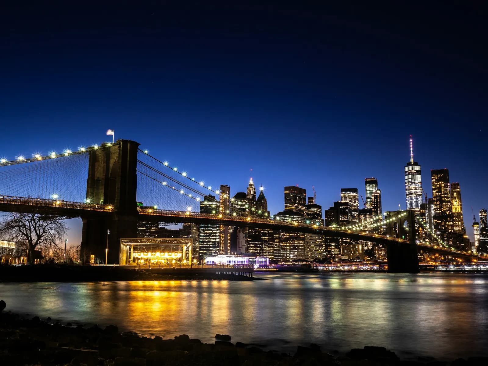 Brooklyn Bridge and the illuminated Manhattan skyline
